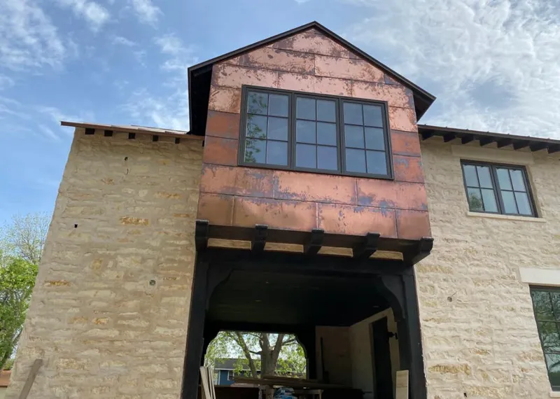 Copper metal panel facade on a stone building for Metal Roof Coating in Sun Valley